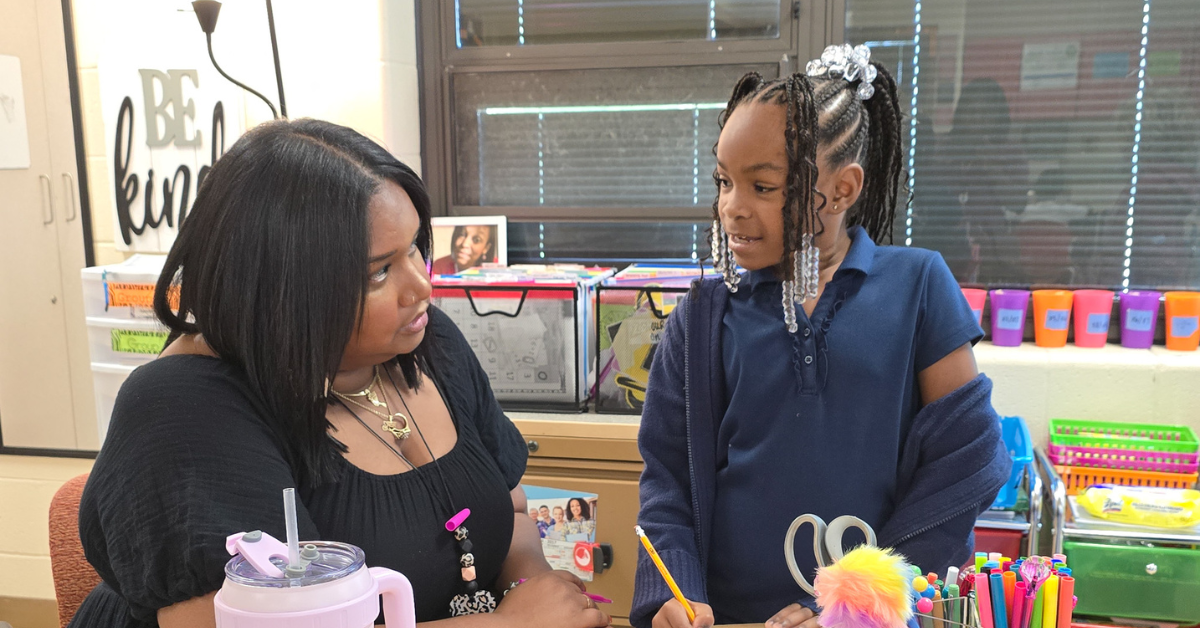 teacher supporting student asking questions about homework